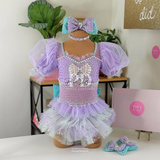 Pearl Dazzle lavender rhinestone dance costume with pearl bow bodice, puff tulle sleeves, layered sparkle tutu skirt, matching headpiece and dance accessories for young competition dancers

